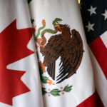 FILE PHOTO: Flags are pictured during the fifth round of NAFTA talks involving the United States Mexico and Canada in Mexico City